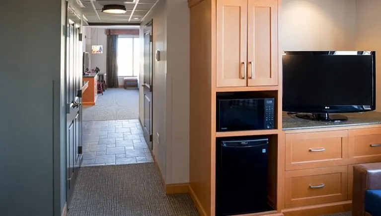 The mini-fridge and hallway in the  Deluxe Family Suite((Accessible bathtub)
